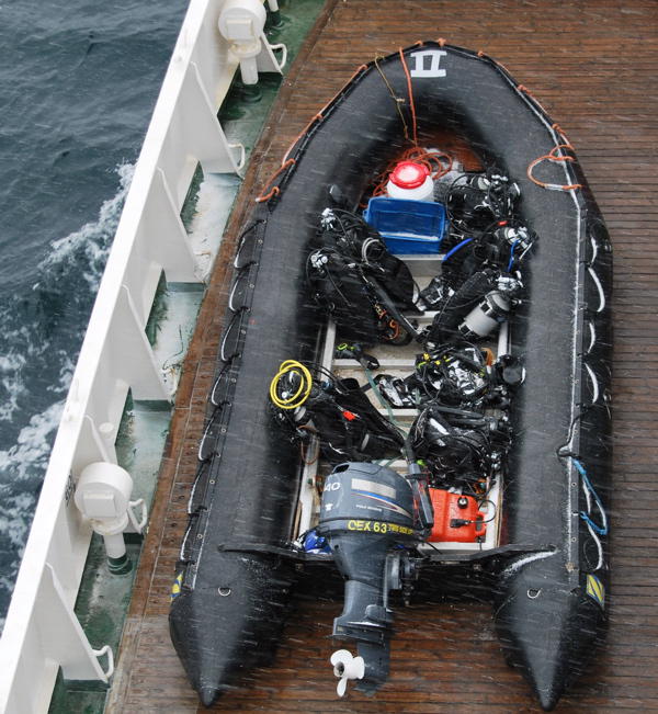 The zodiac with the diving equipment in icy rain (picture by Gunther Herrmann)